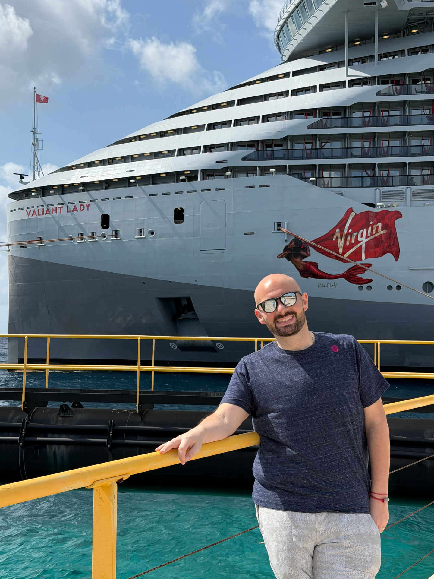 Chris, owner of Golden Hour Travel, in front of Virgin Voyages' Valiant Lady